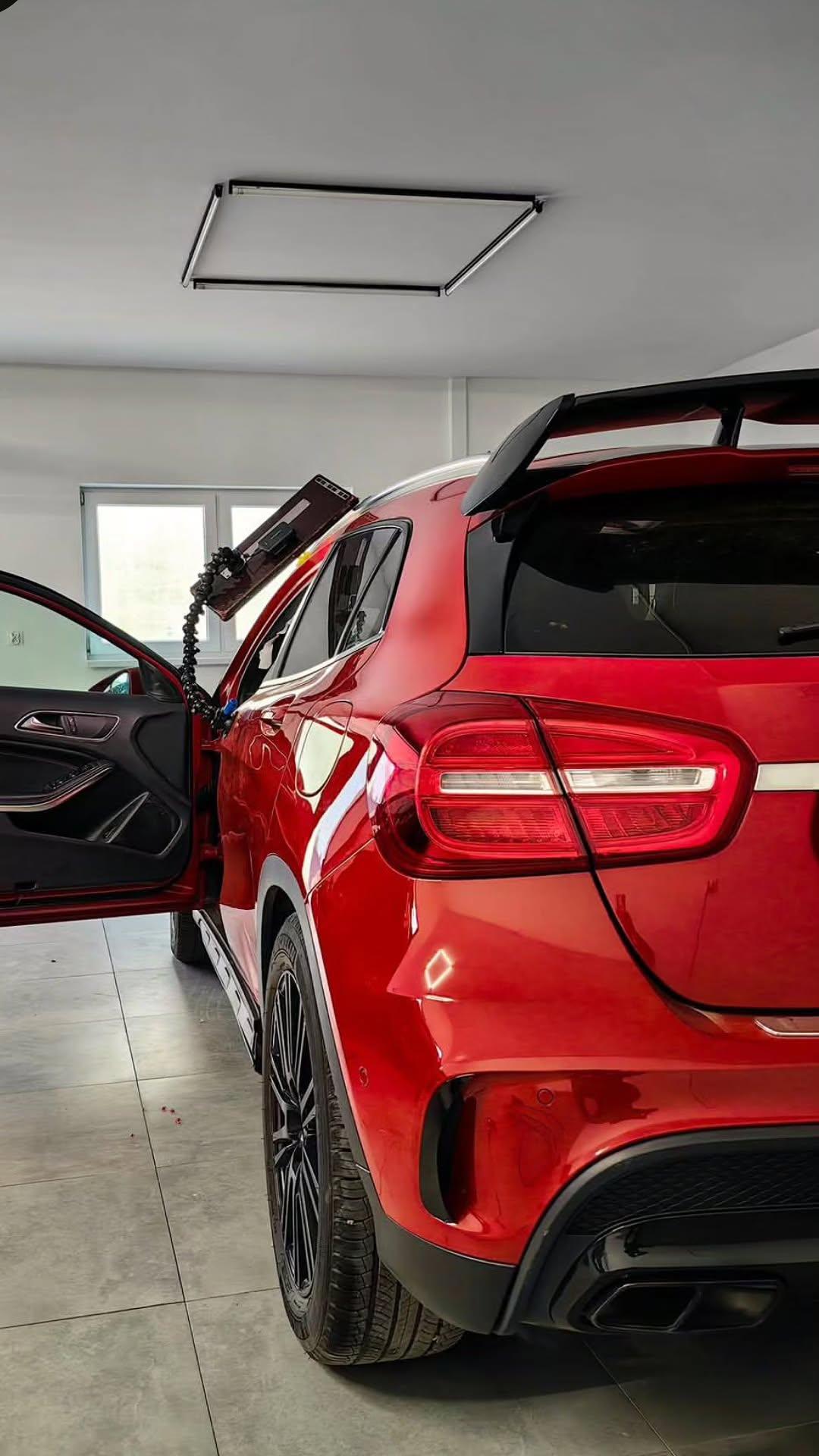 Czerwony Mercedes GLA podczas naprawy wgniecenia metodą PDR